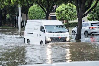 White van driving through flooded street