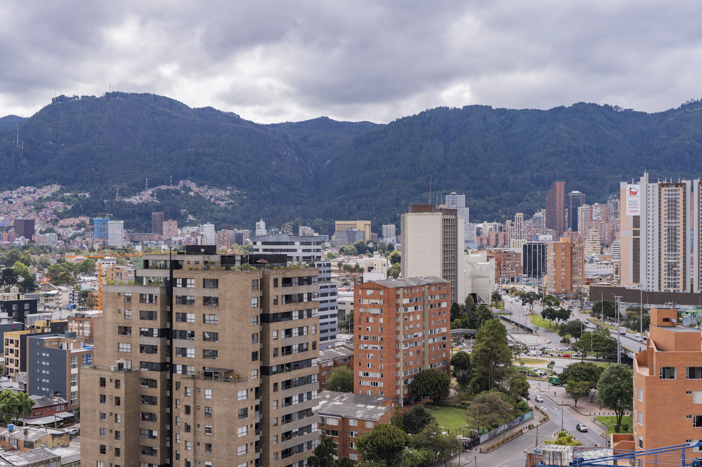 Bogota Colombia cityscape with buildings spread across the Andean plateau and mountains with blue tones in the misty atmosphere above the capital city