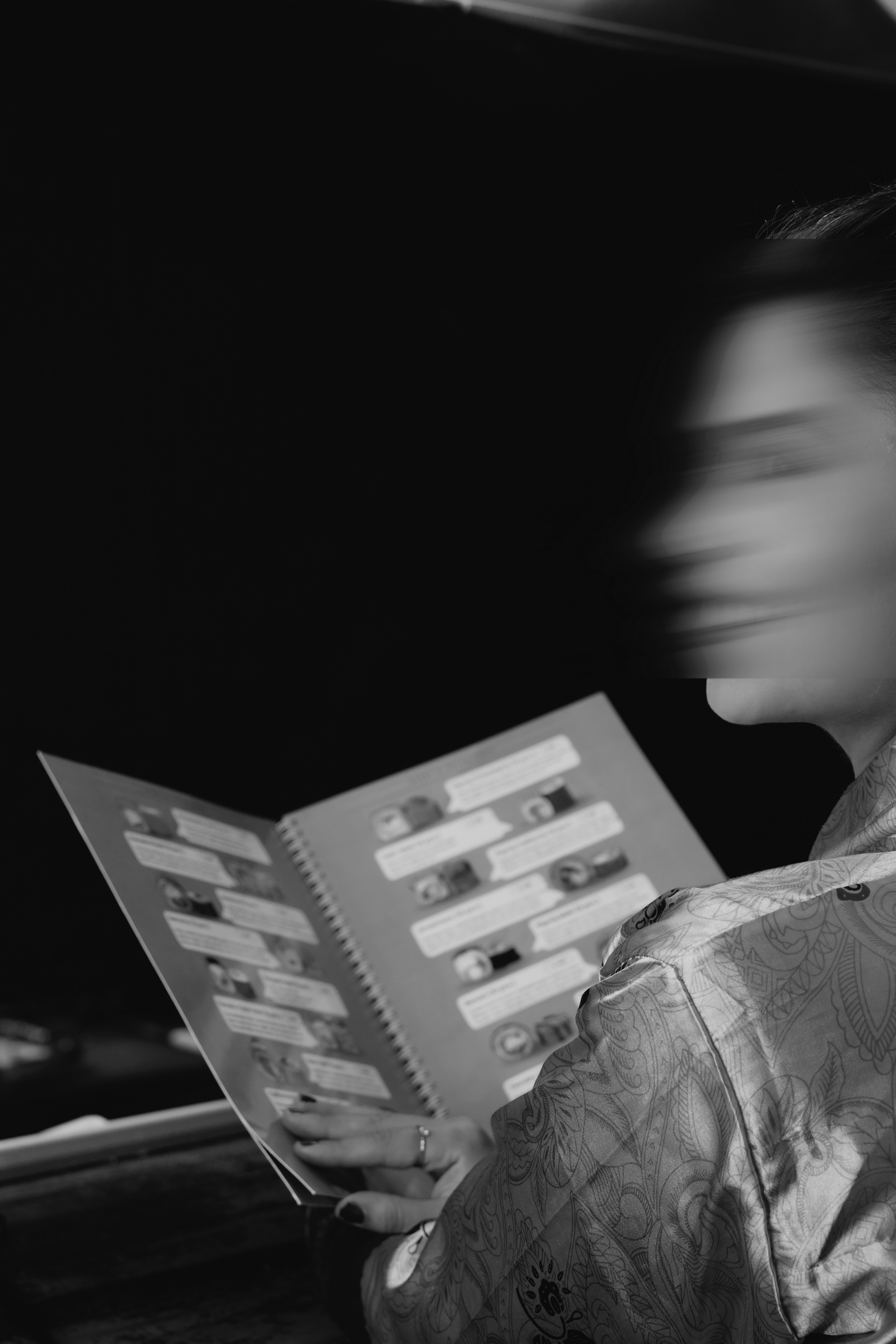 Woman in kimono looking at a book