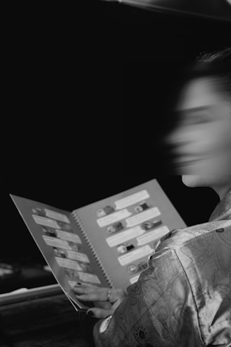 Woman in kimono looking at a book