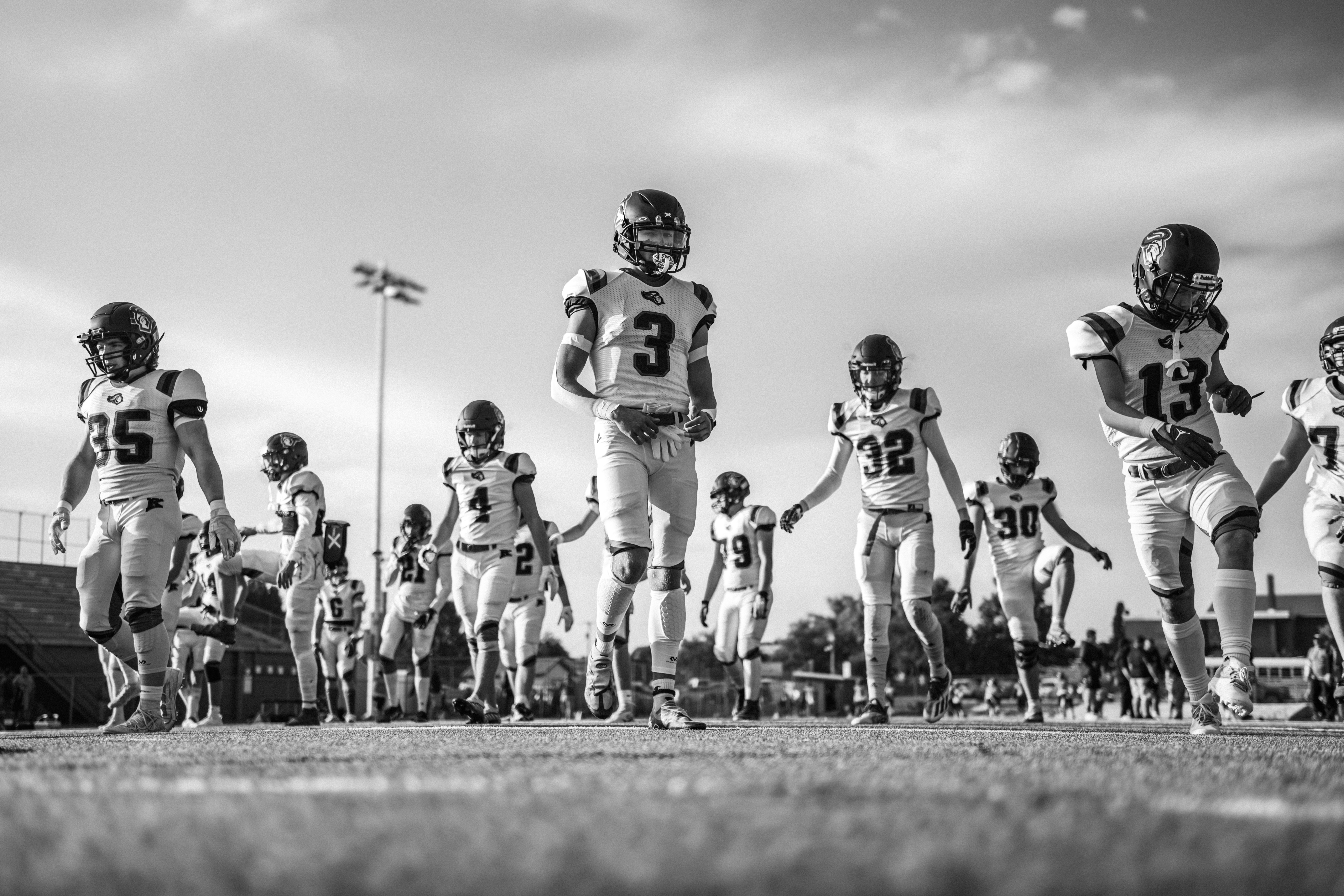 American football players running onto the field