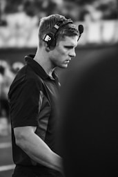 Man wearing headset on a football field