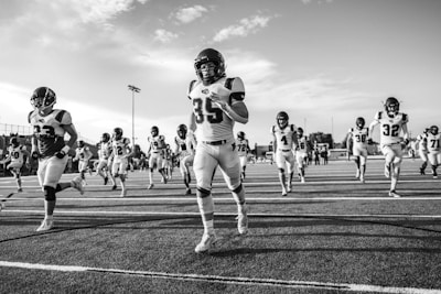 Football team running onto the field during a game.