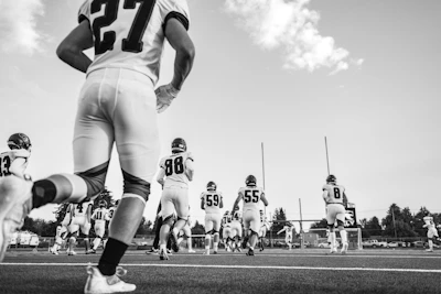Football players running onto the field