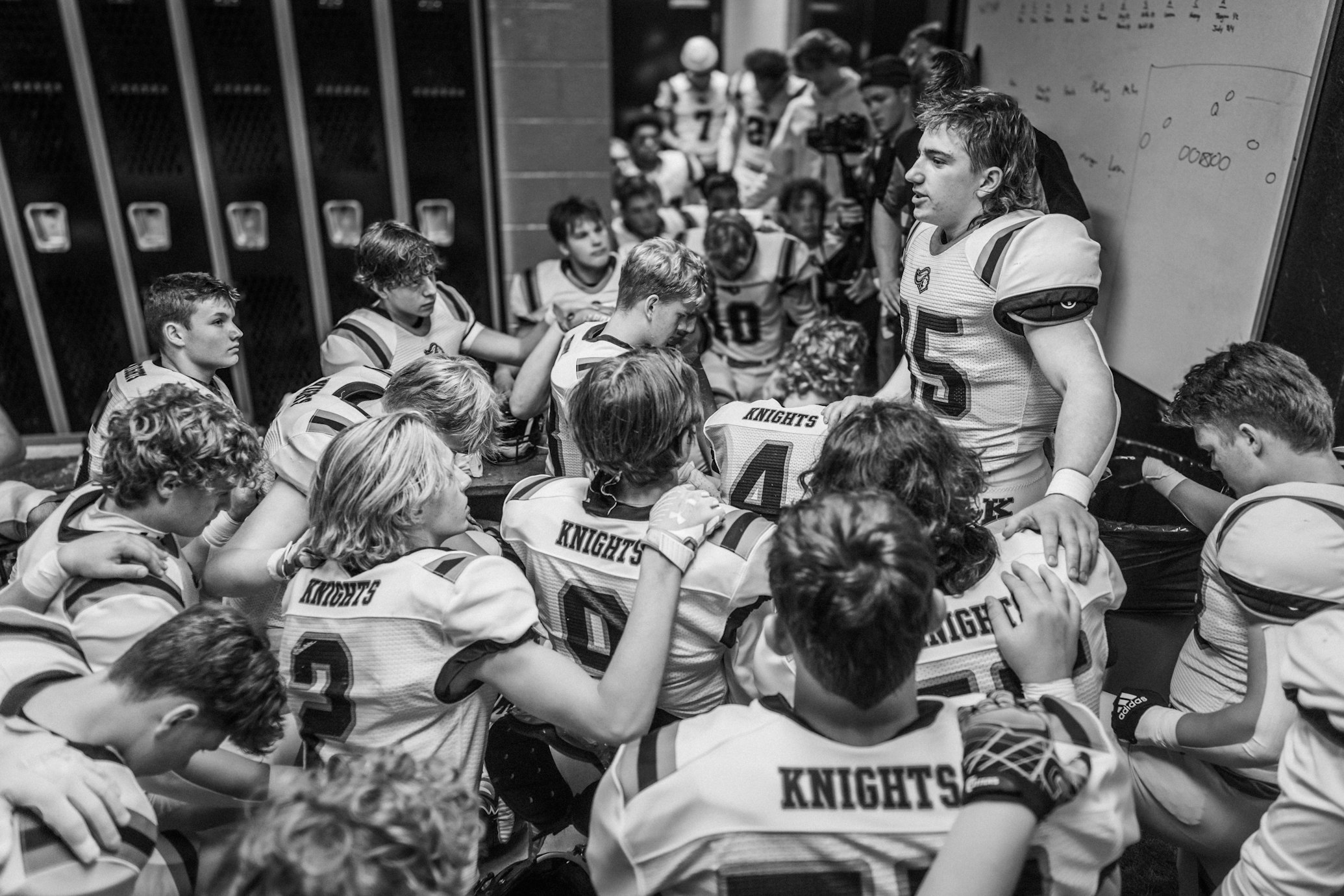 Football team huddles in locker room before game