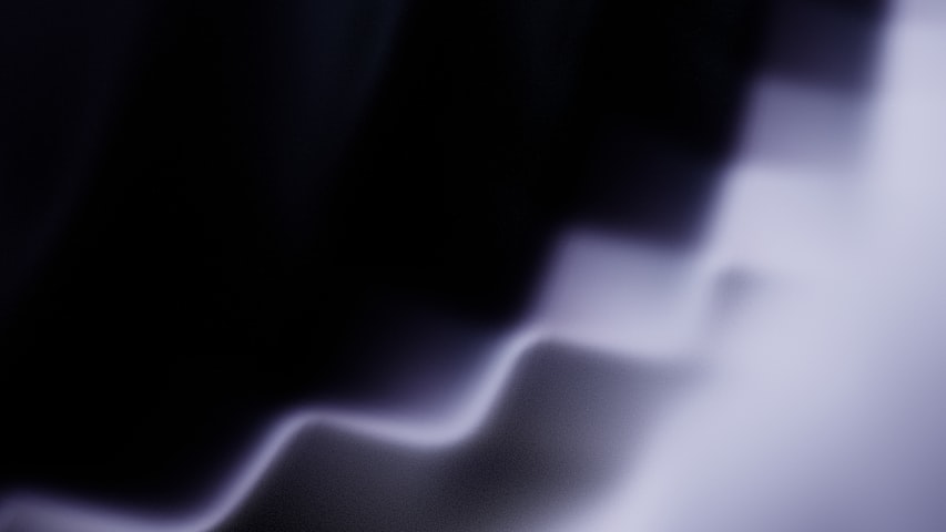Abstract wavy light streaks on dark background