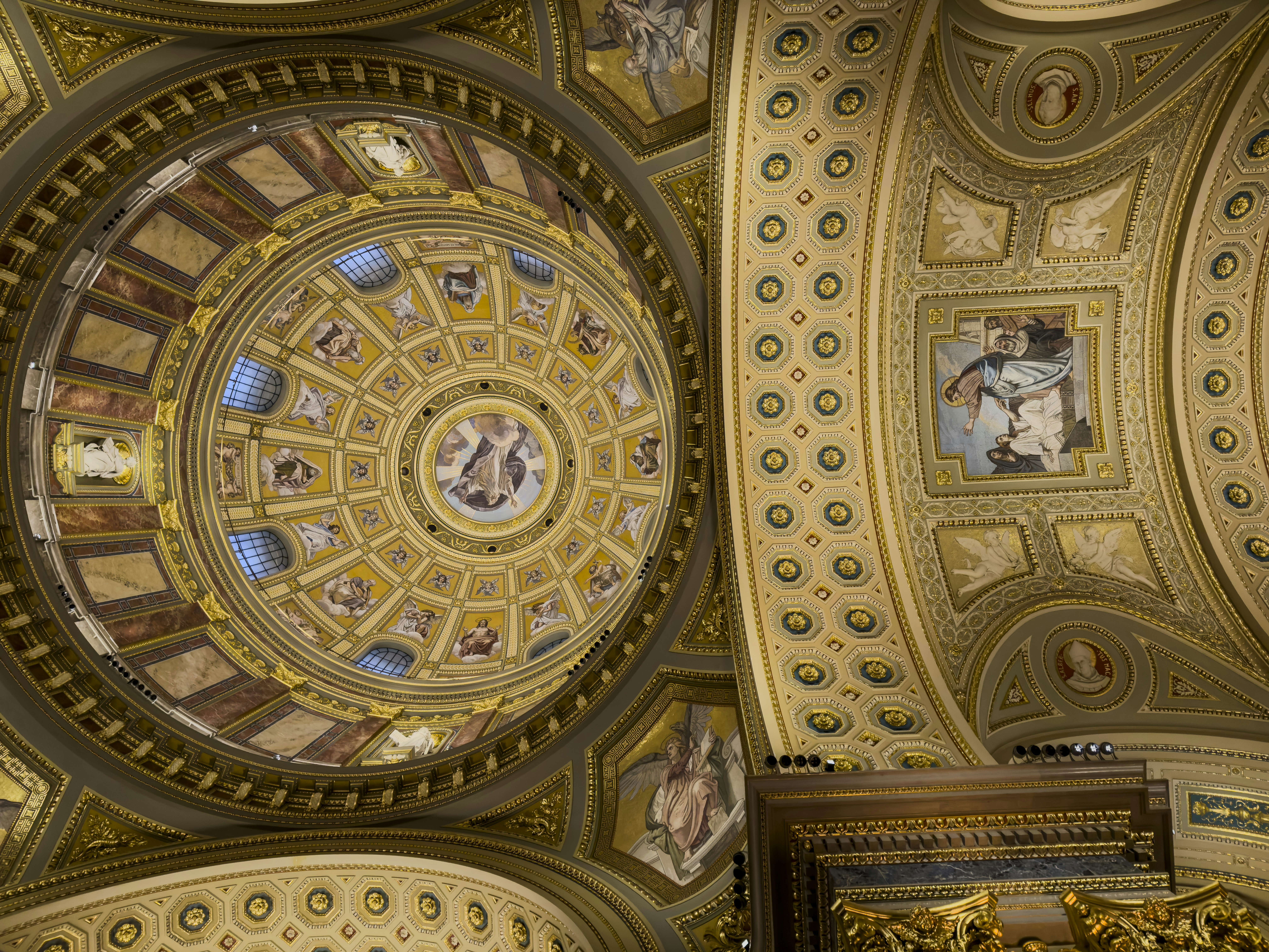 Intricate ornate dome interior with painted frescoes.