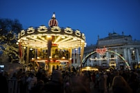 A brightly lit carousel at a night market.