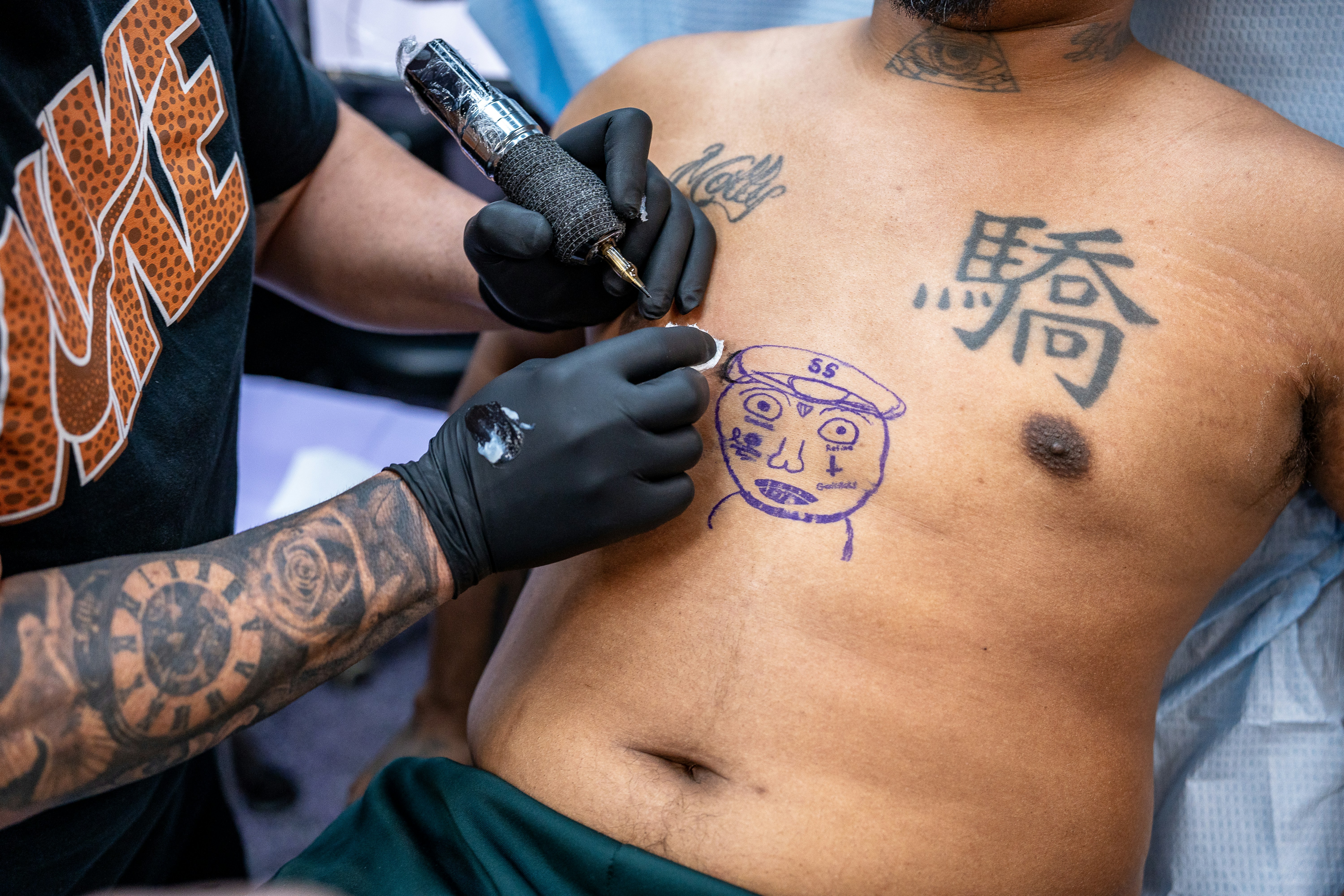 Tattoo artist inks a face