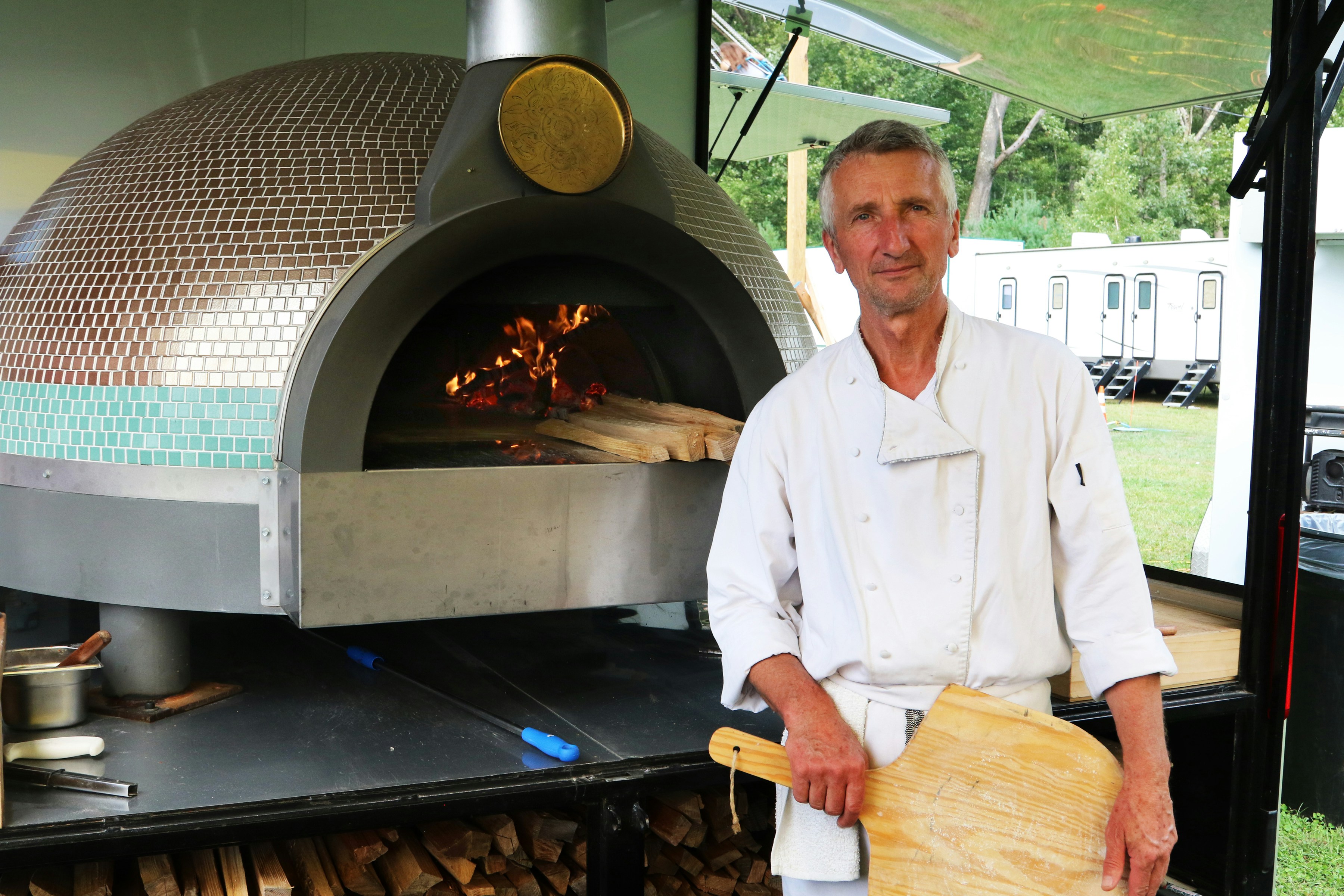 Restaurant chef assessing a modern pizza oven