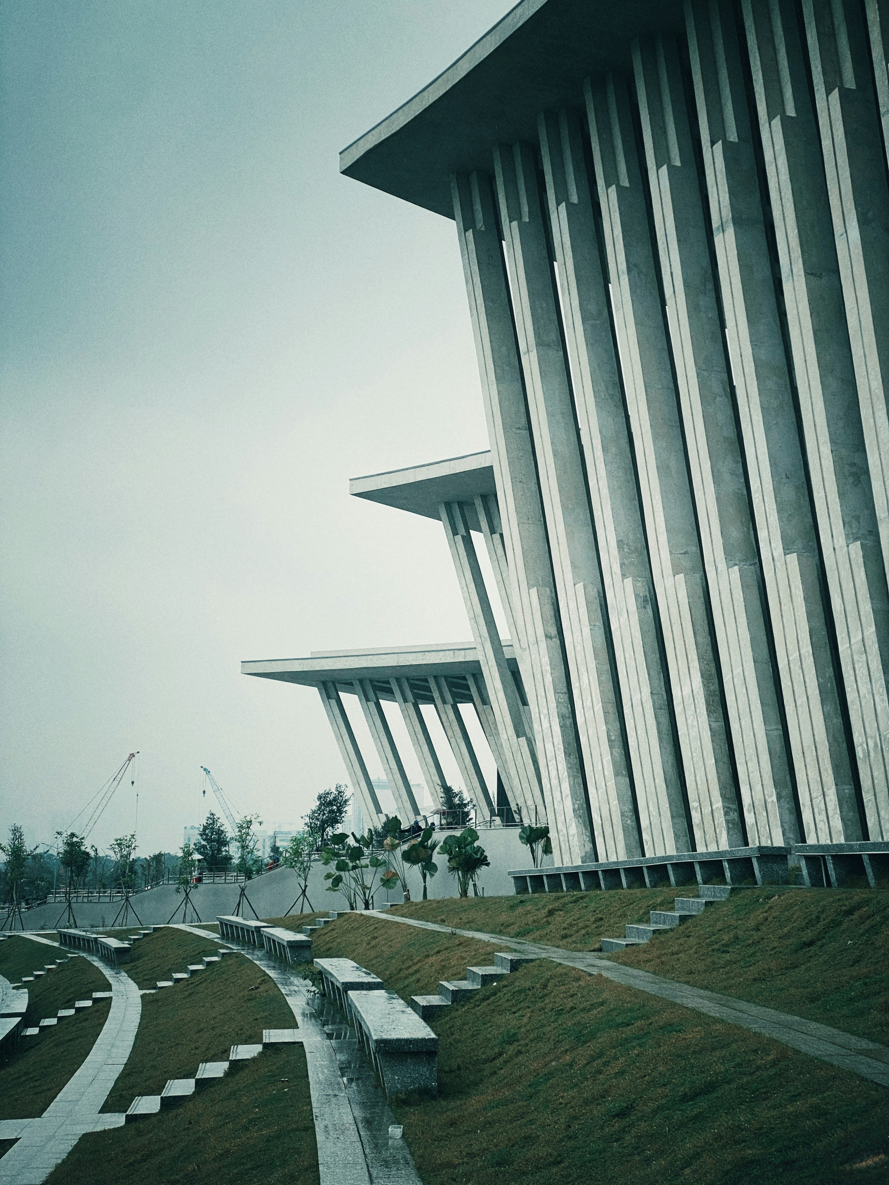 Modern architecture with geometric facade and tiered landscape