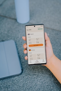 Hand holding phone displaying e-sim options for thailand and germany.