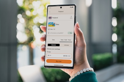 Person holding a smartphone displaying travel booking