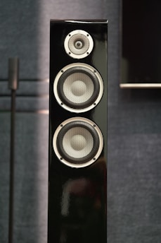 A tall black speaker with three drivers.