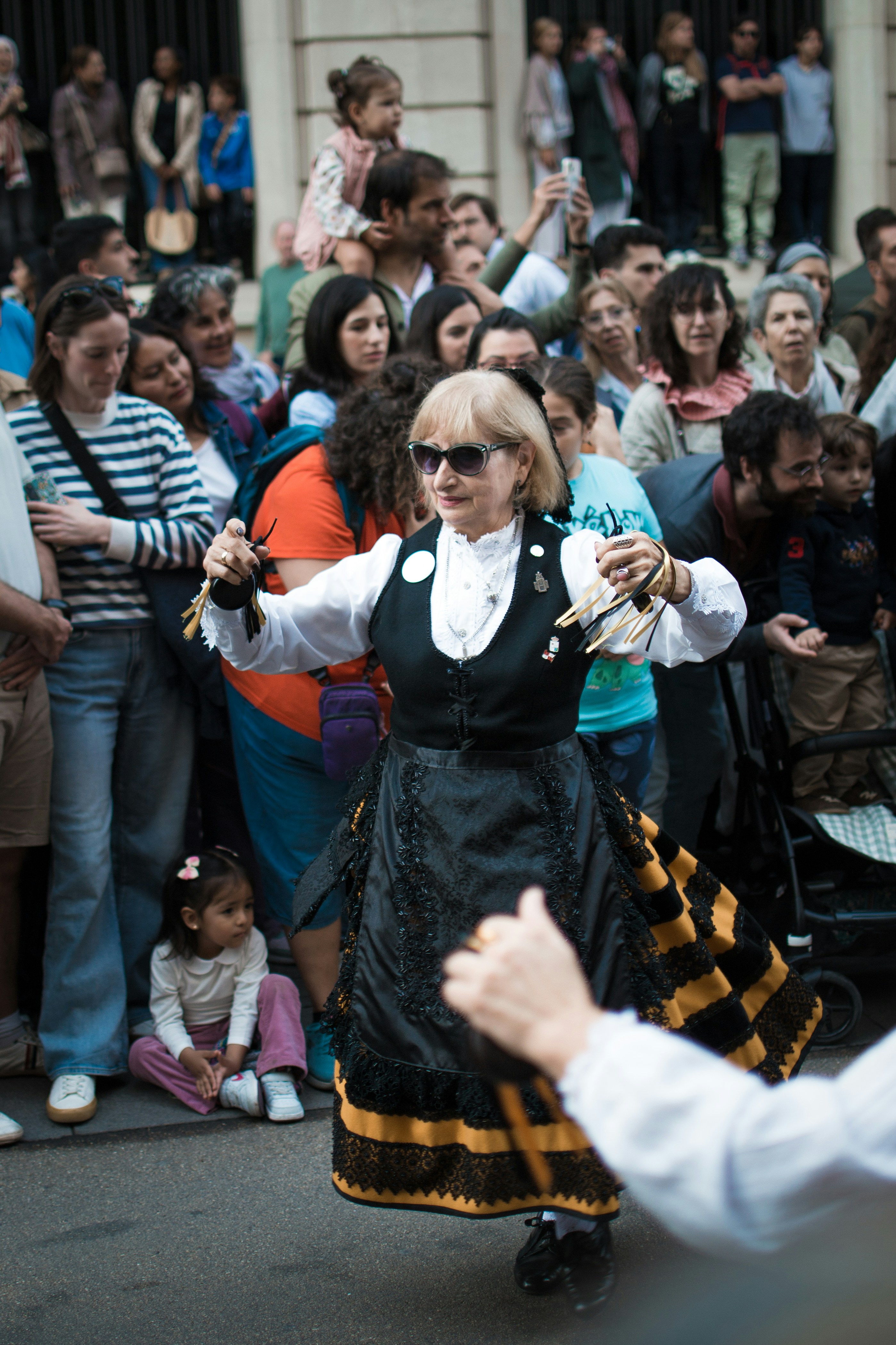 Woman in traditional dress dancing for a crowd