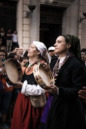 Women in traditional dress playing tambourines