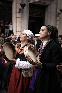 Women in traditional dress playing tambourines
