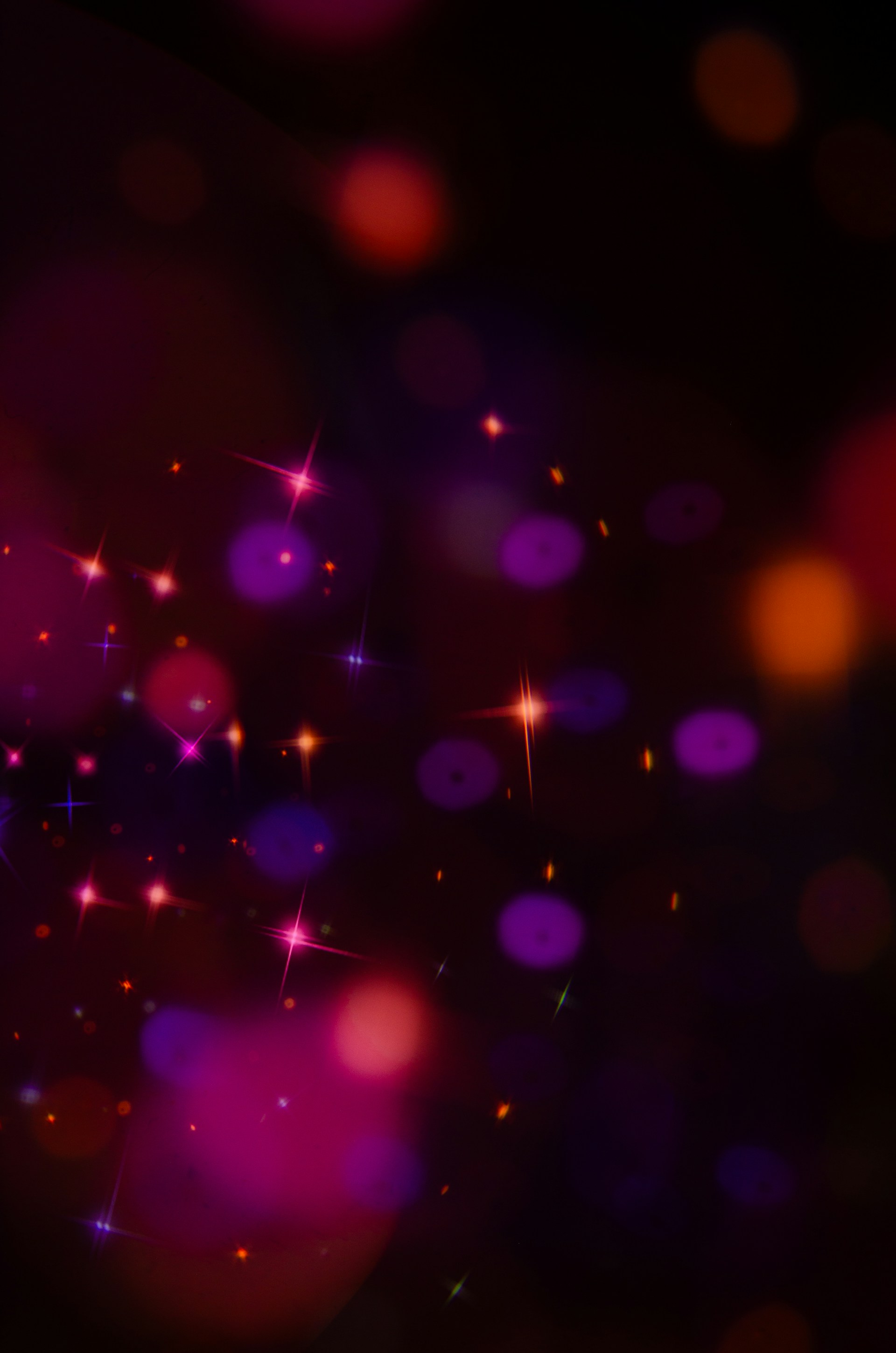 Abstract bokeh lights and sparkles on dark background