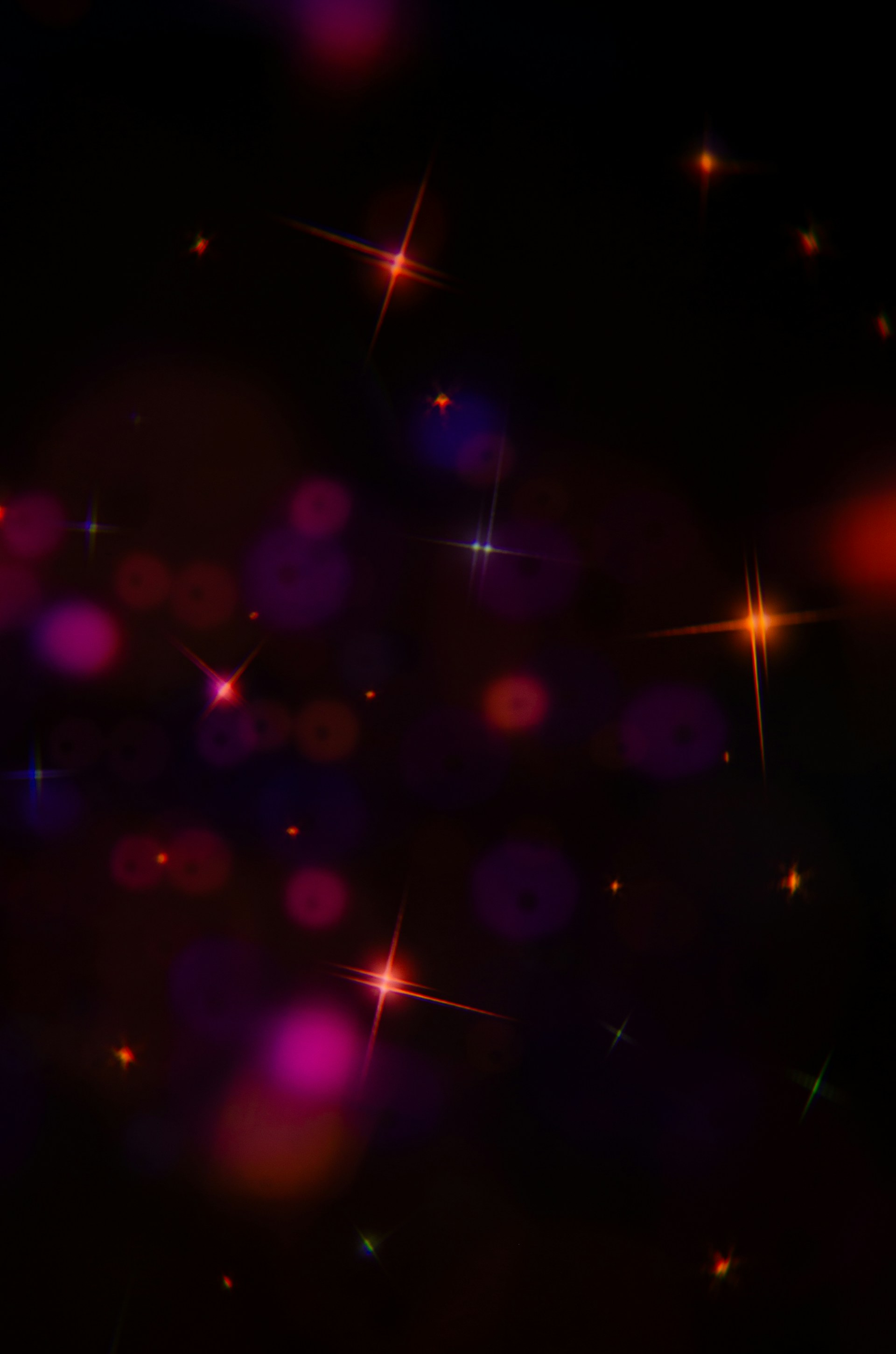 Sparkling stars and bokeh lights on black background