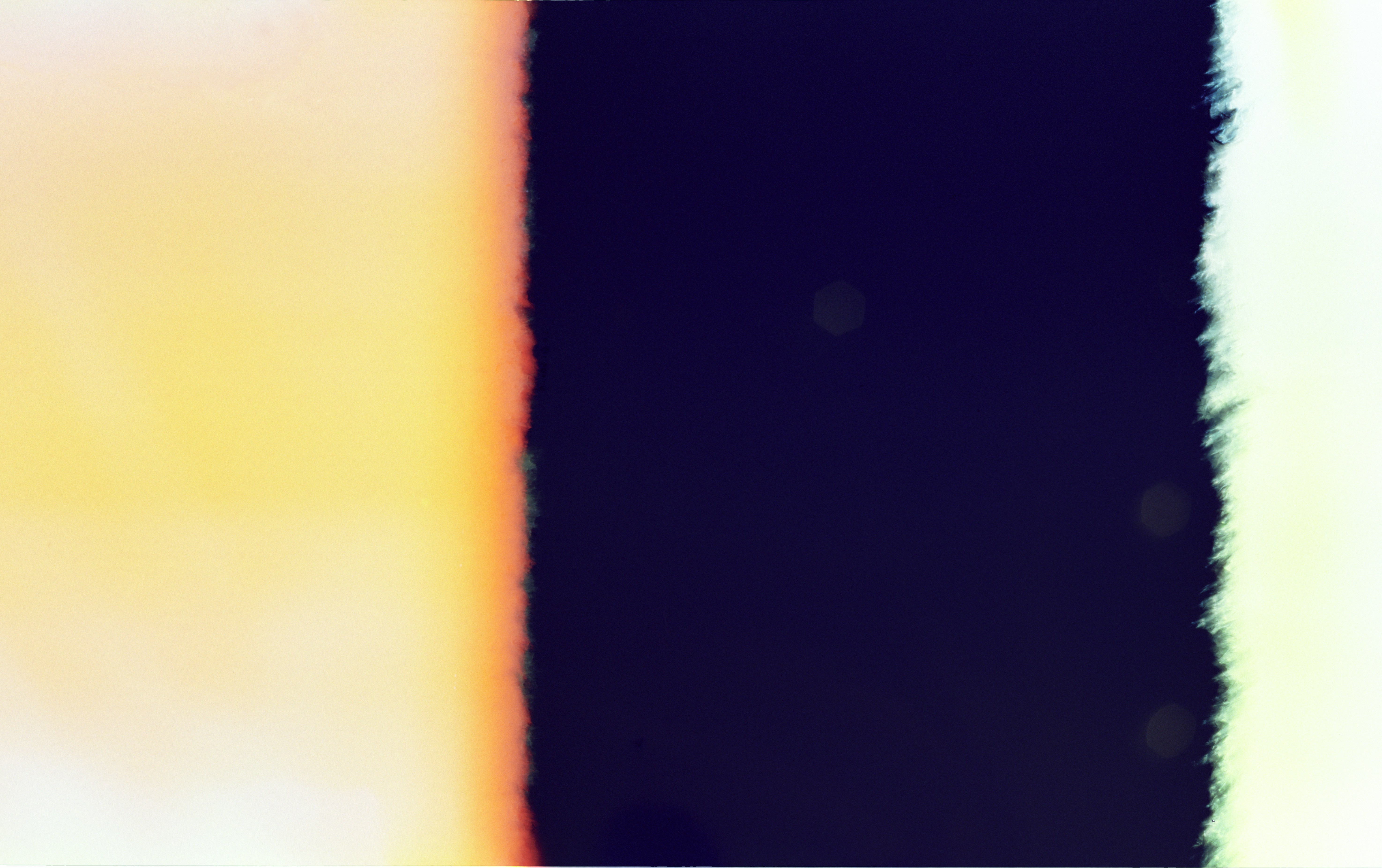 Abstract colorful light leak effect on dark background