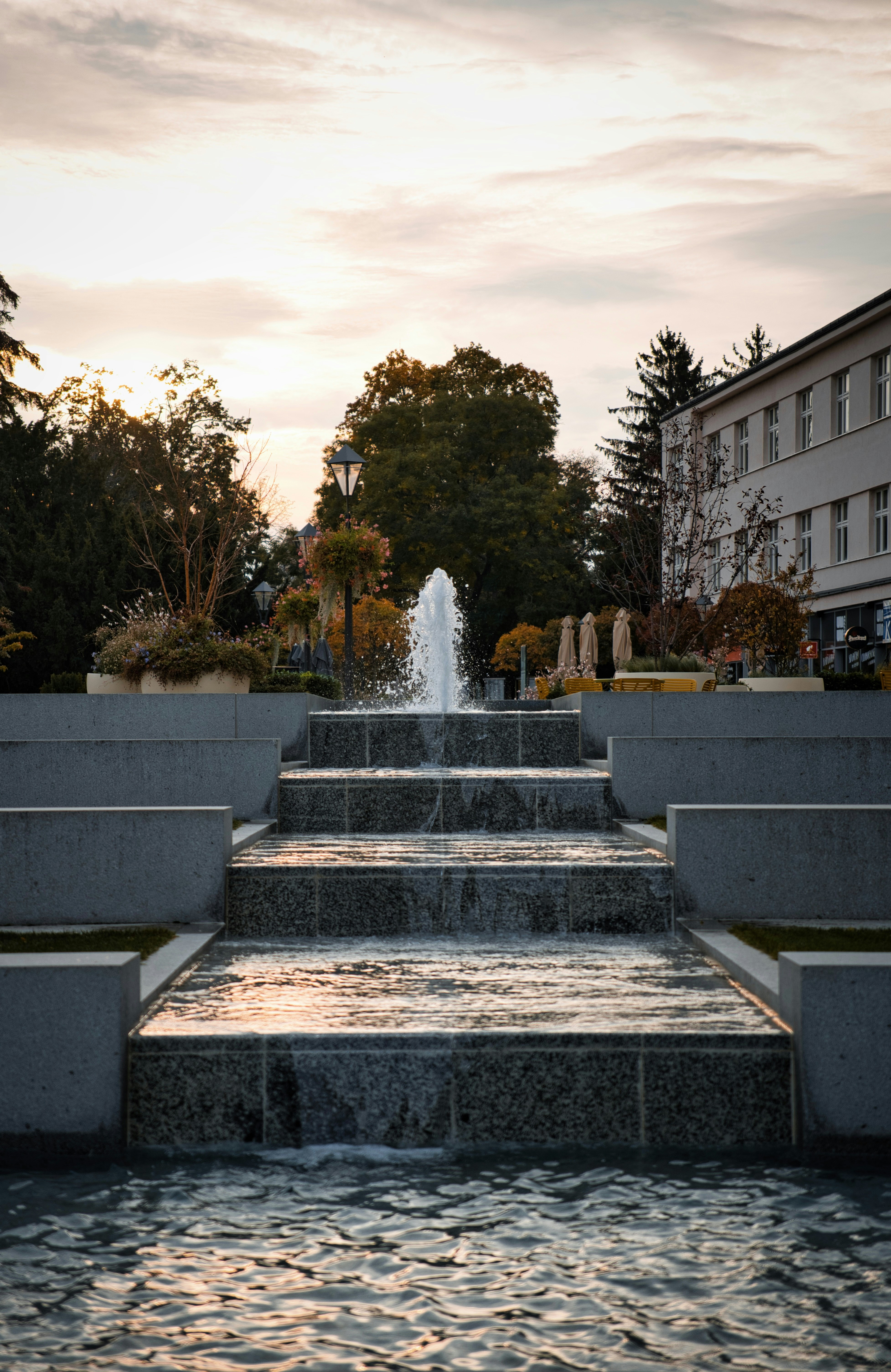 A tiered fountain cascades water down steps.