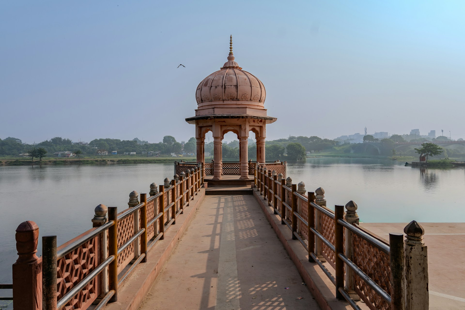 A historic pavilion on a bridge over water.