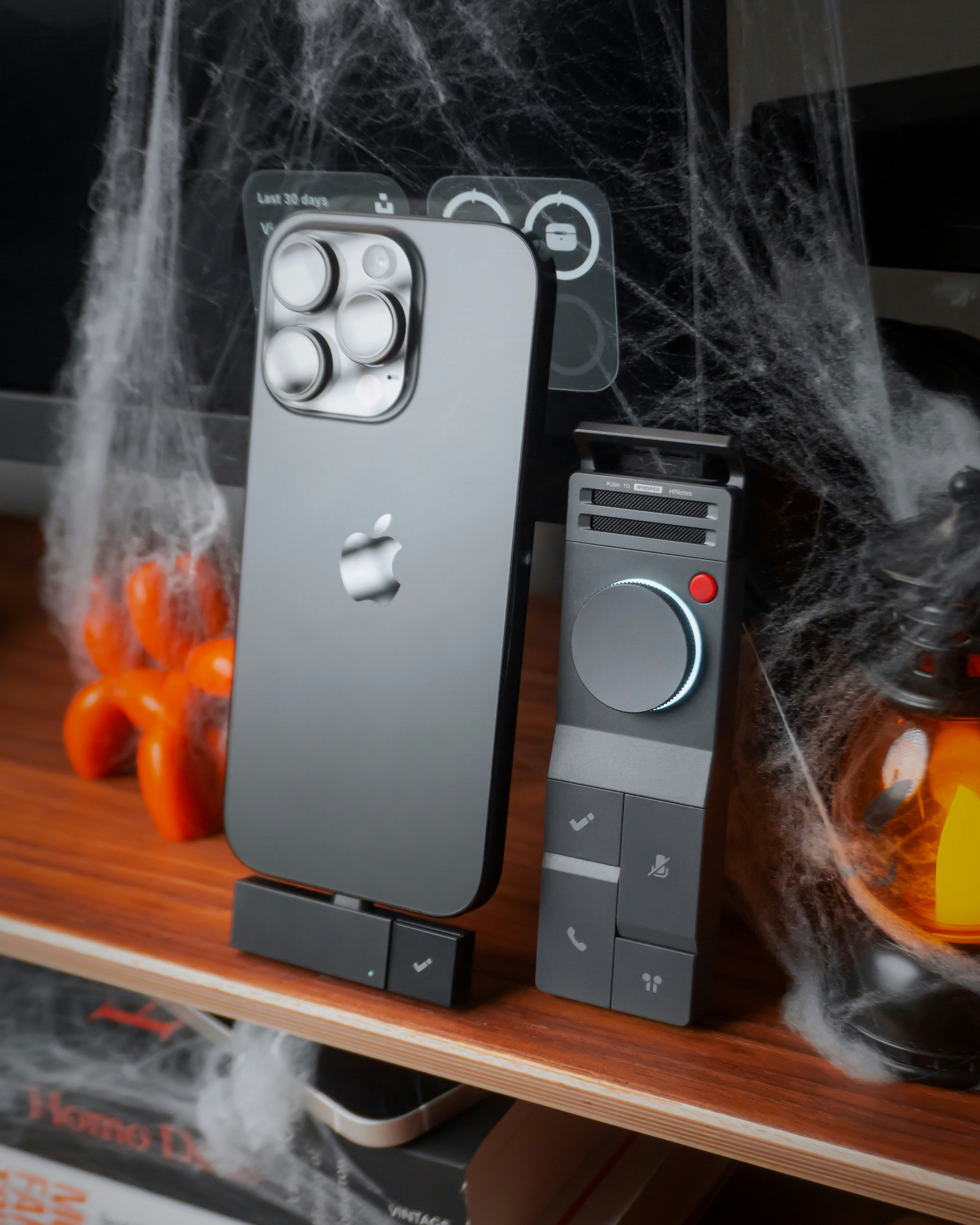 Smartphone with accessories on shelf with cobwebs