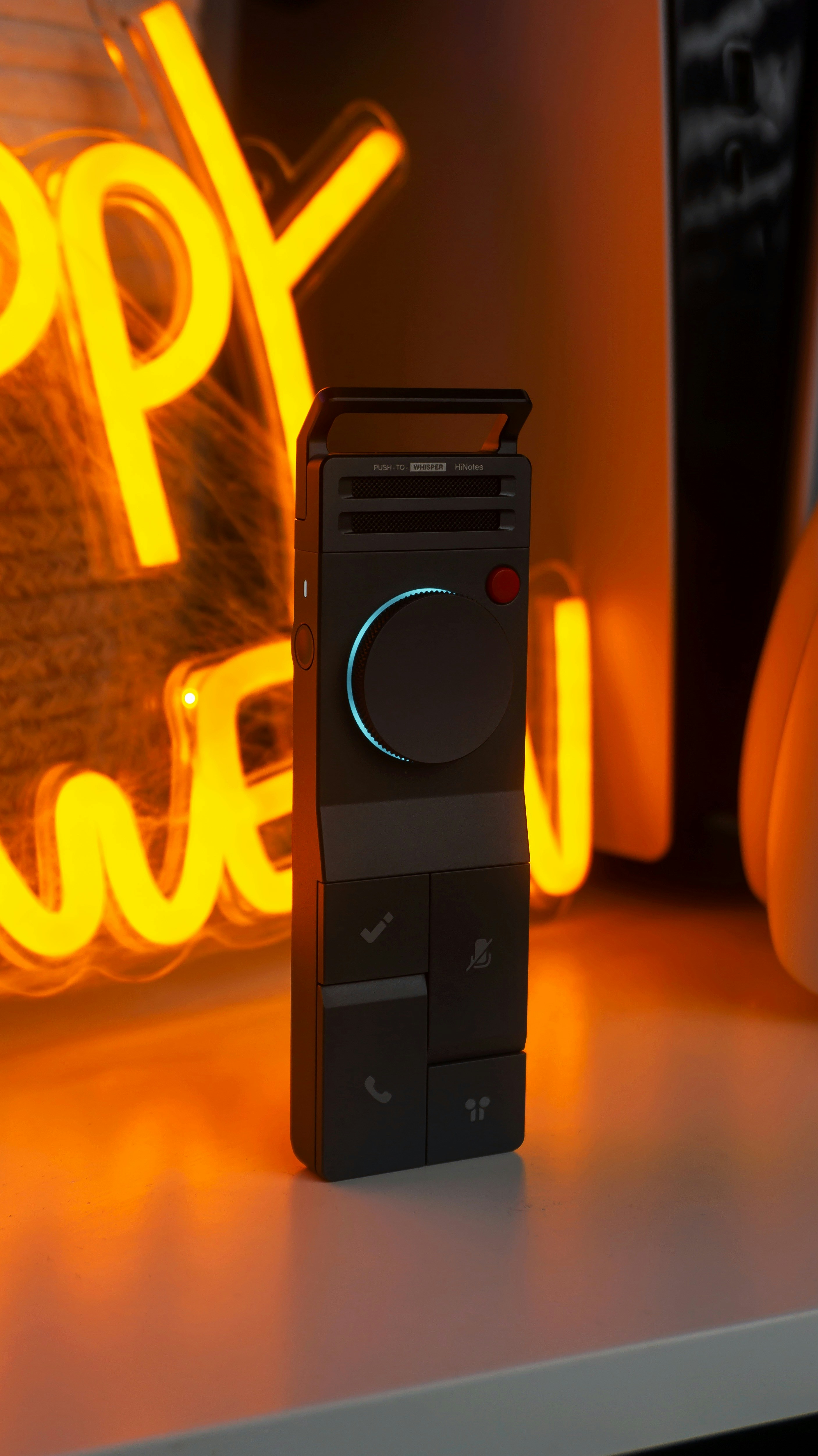 Black device with buttons and neon light