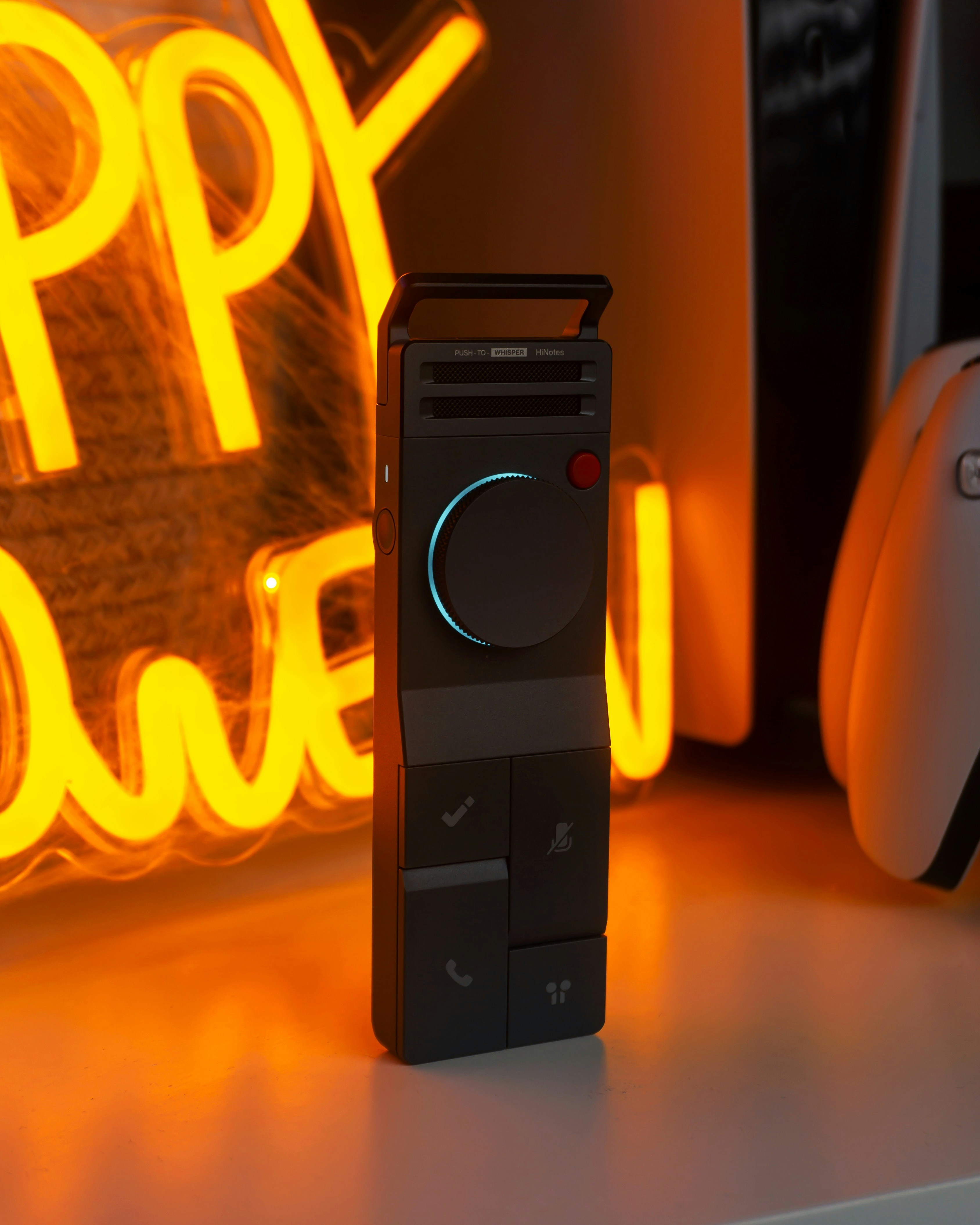 Modern black device with glowing neon sign