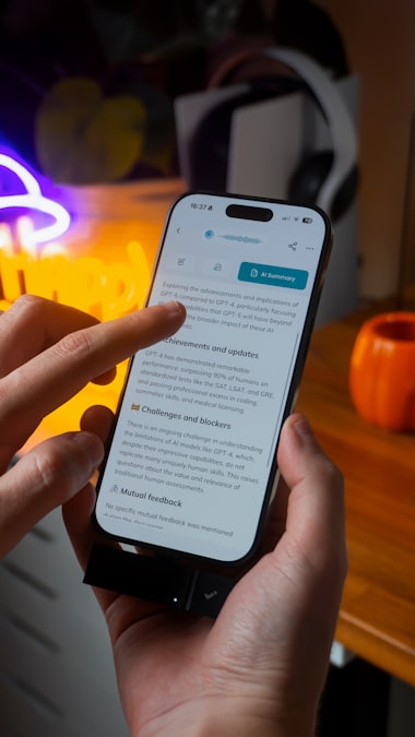 A close-up of hands scrolling through an article on a smartphone screen, representing the external, public side of voice of customer research