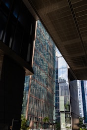 Modern glass buildings reflecting the sky and clouds.