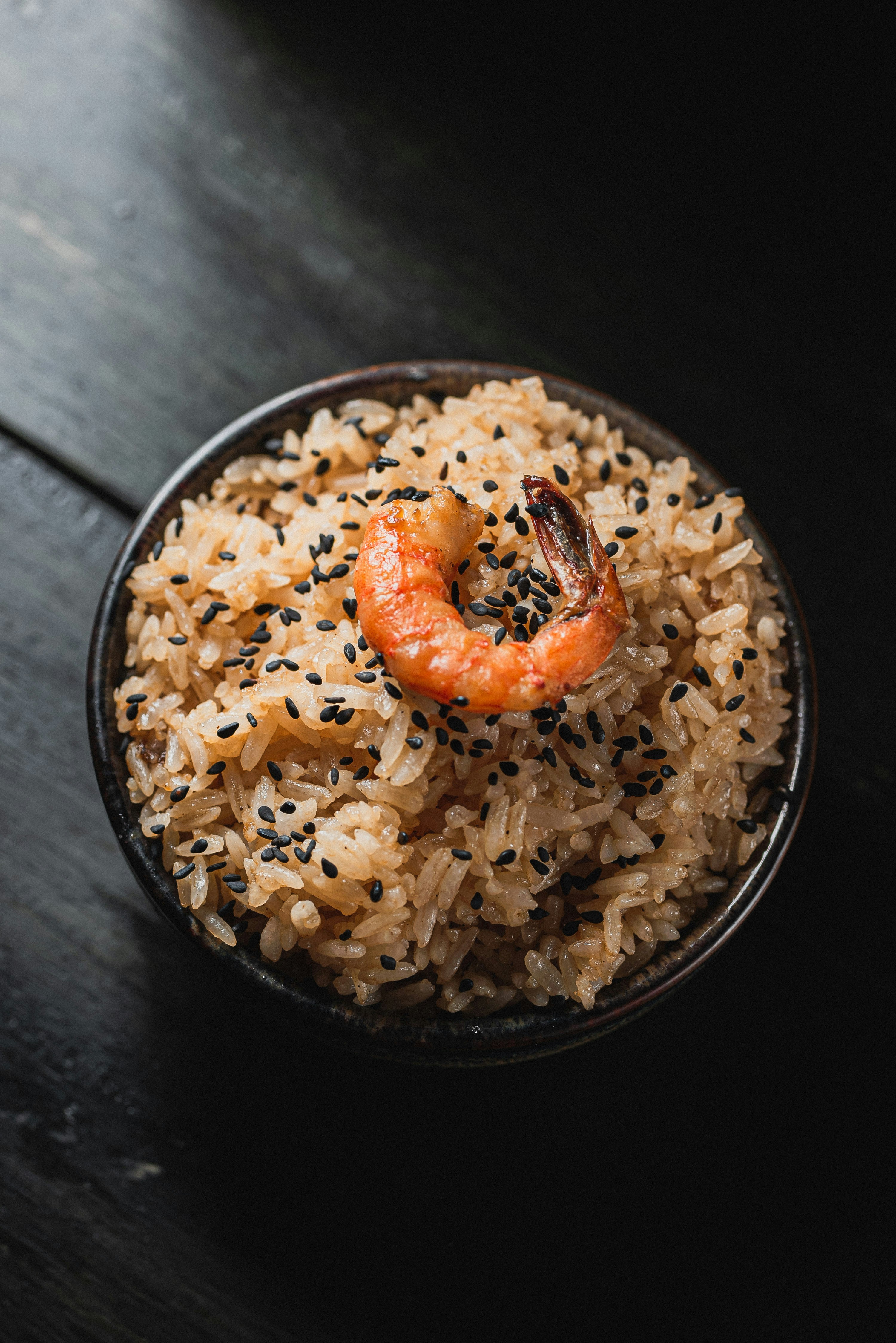 Bowl of rice with shrimp and black sesame seeds