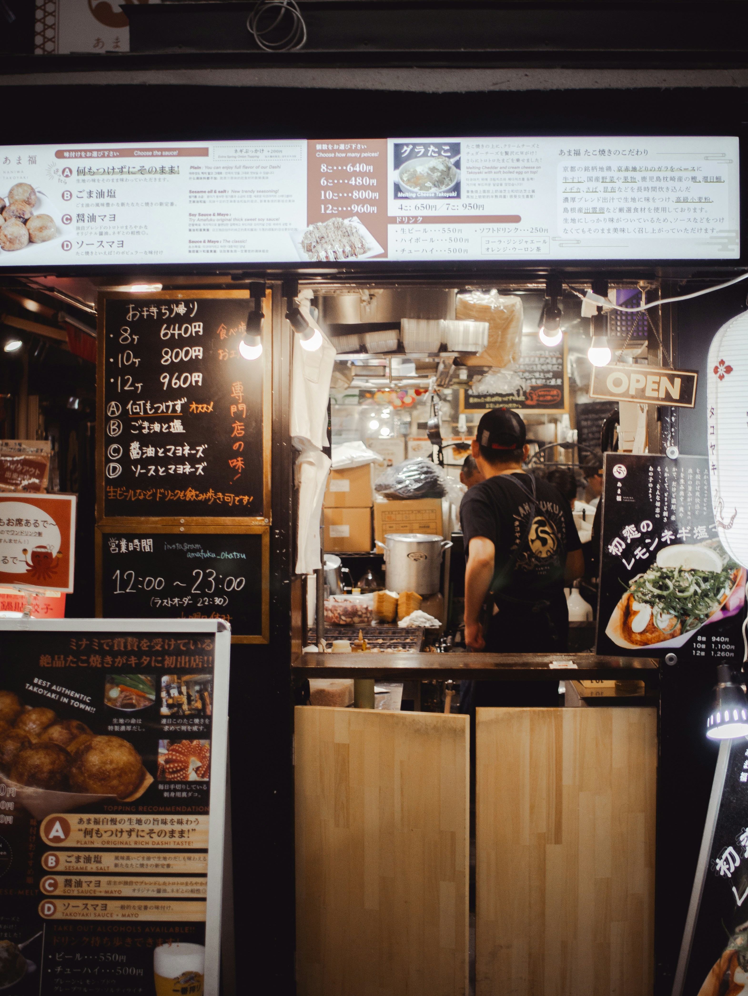 A person working at a food stall at night