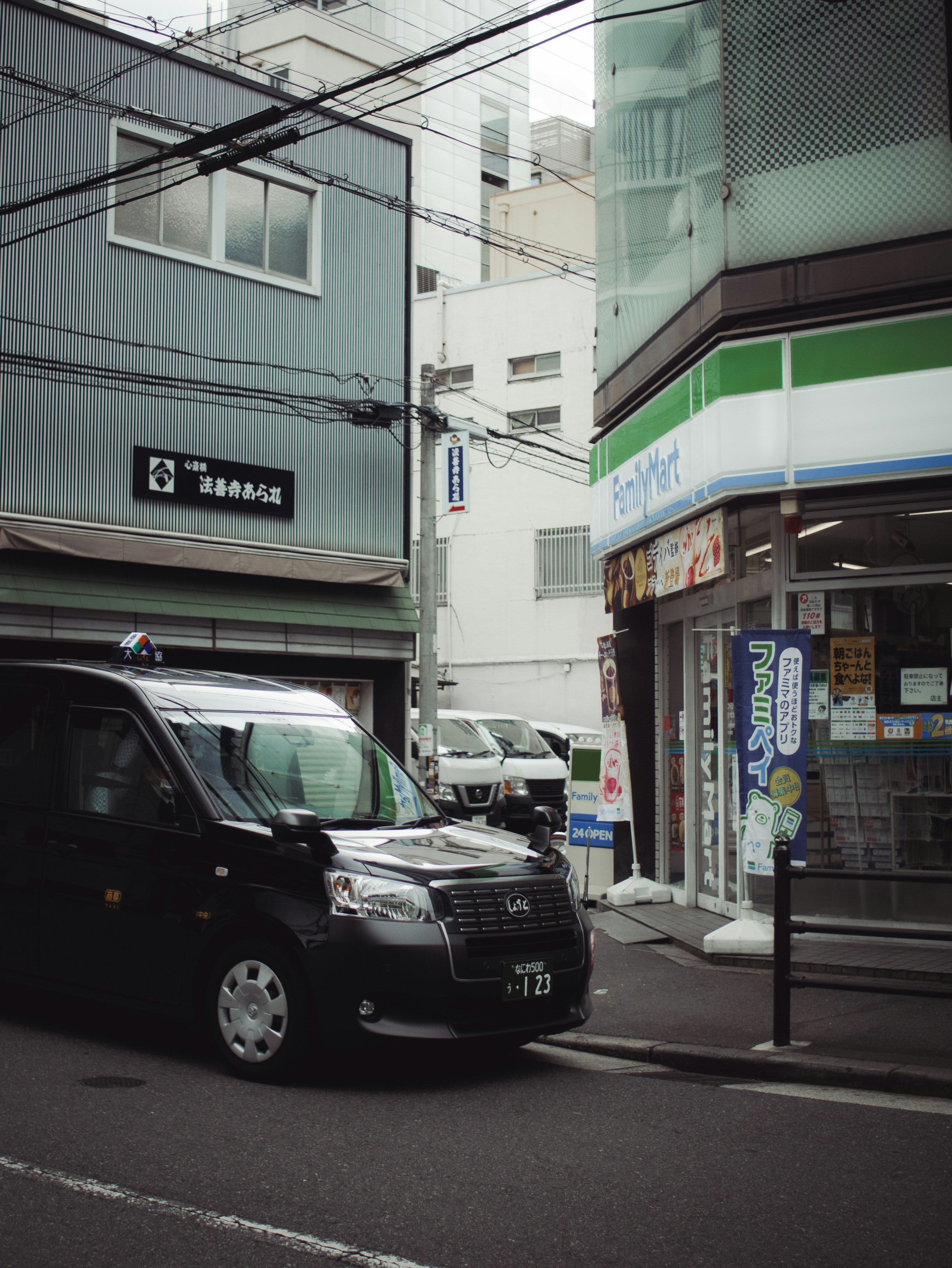 A black taxi parked on a city street.