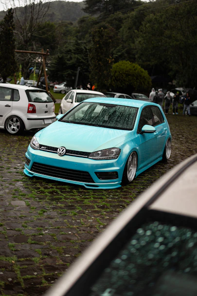 A bright blue volkswagen golf parked outdoors.