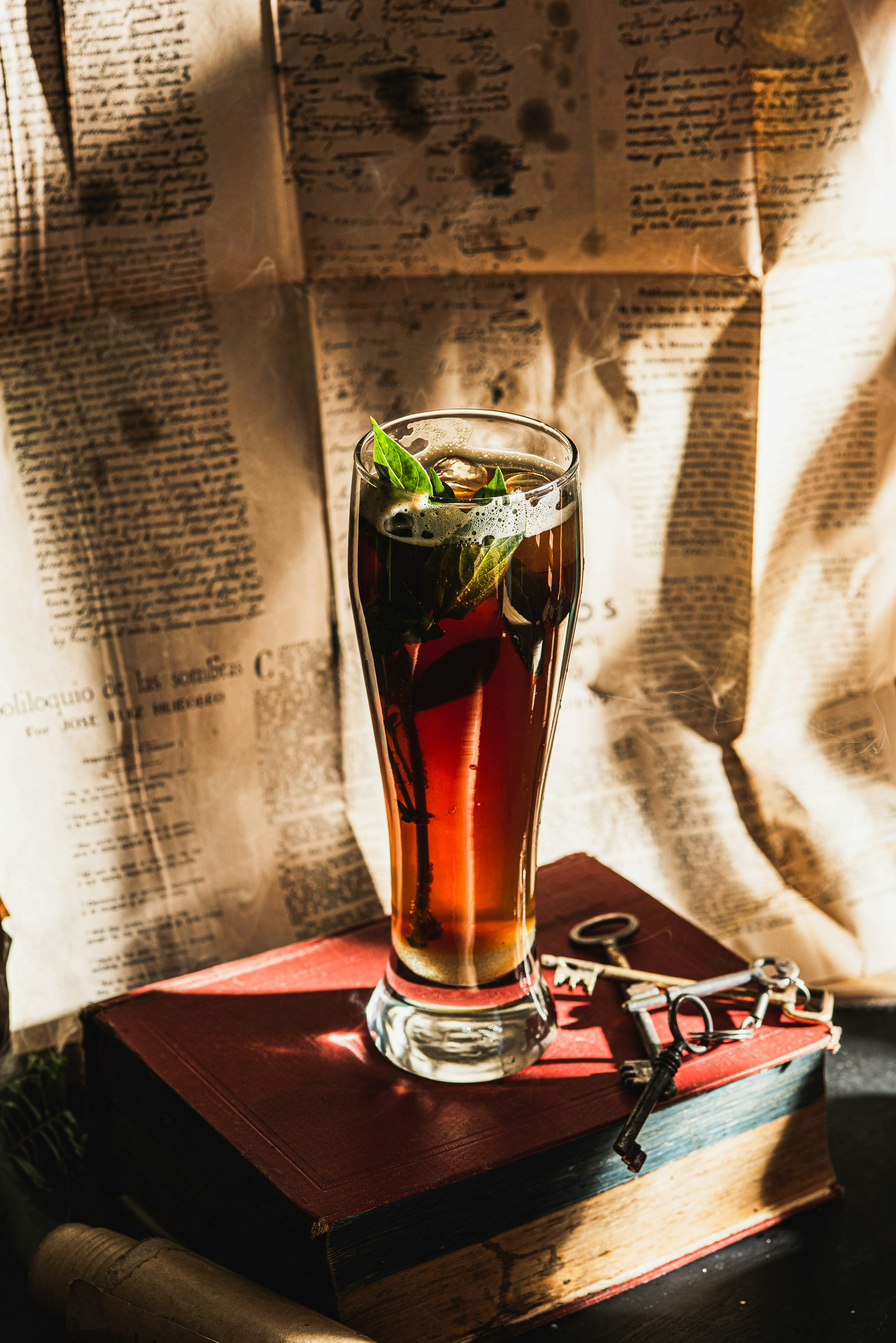 Un vaso alto de té helado con hojas de menta.