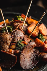 Roasted potatoes with herbs and skewers