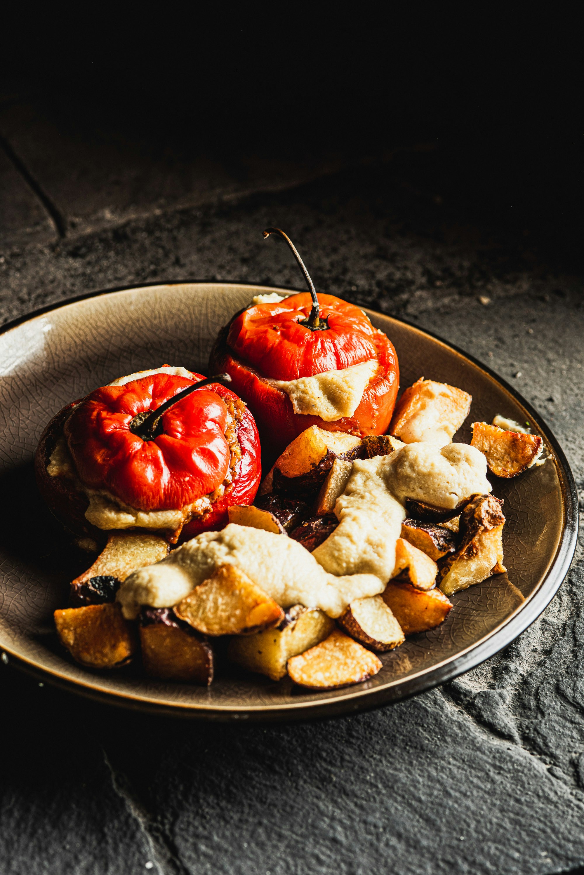 Stuffed tomatoes with roasted potatoes and sauce