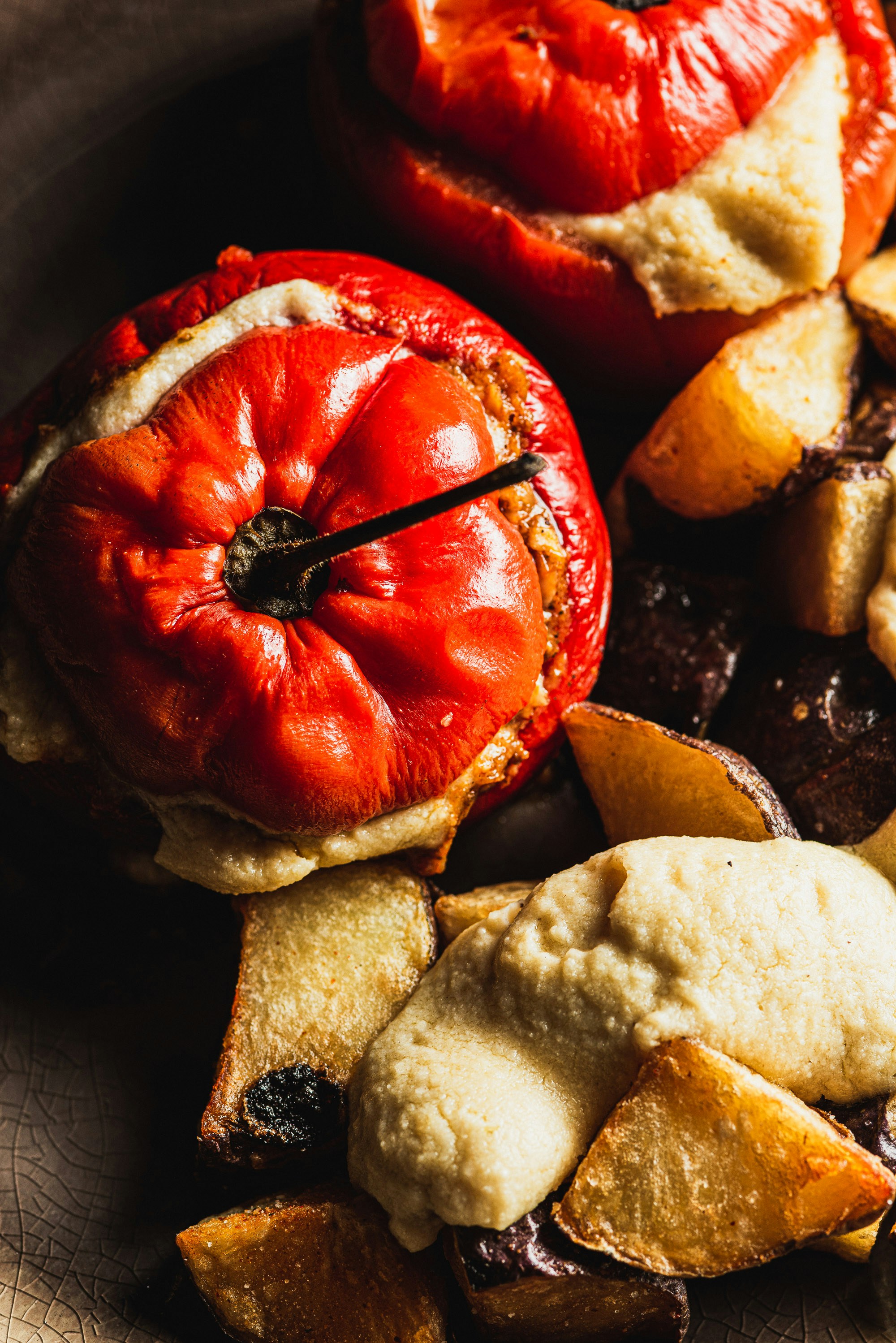 Stuffed red peppers with roasted potatoes and hummus