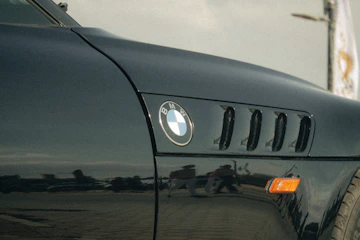 Black BMW car fender with vents and logo