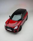 Red mini countryman car with black roof