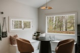 Cozy dining nook with window view of forest.