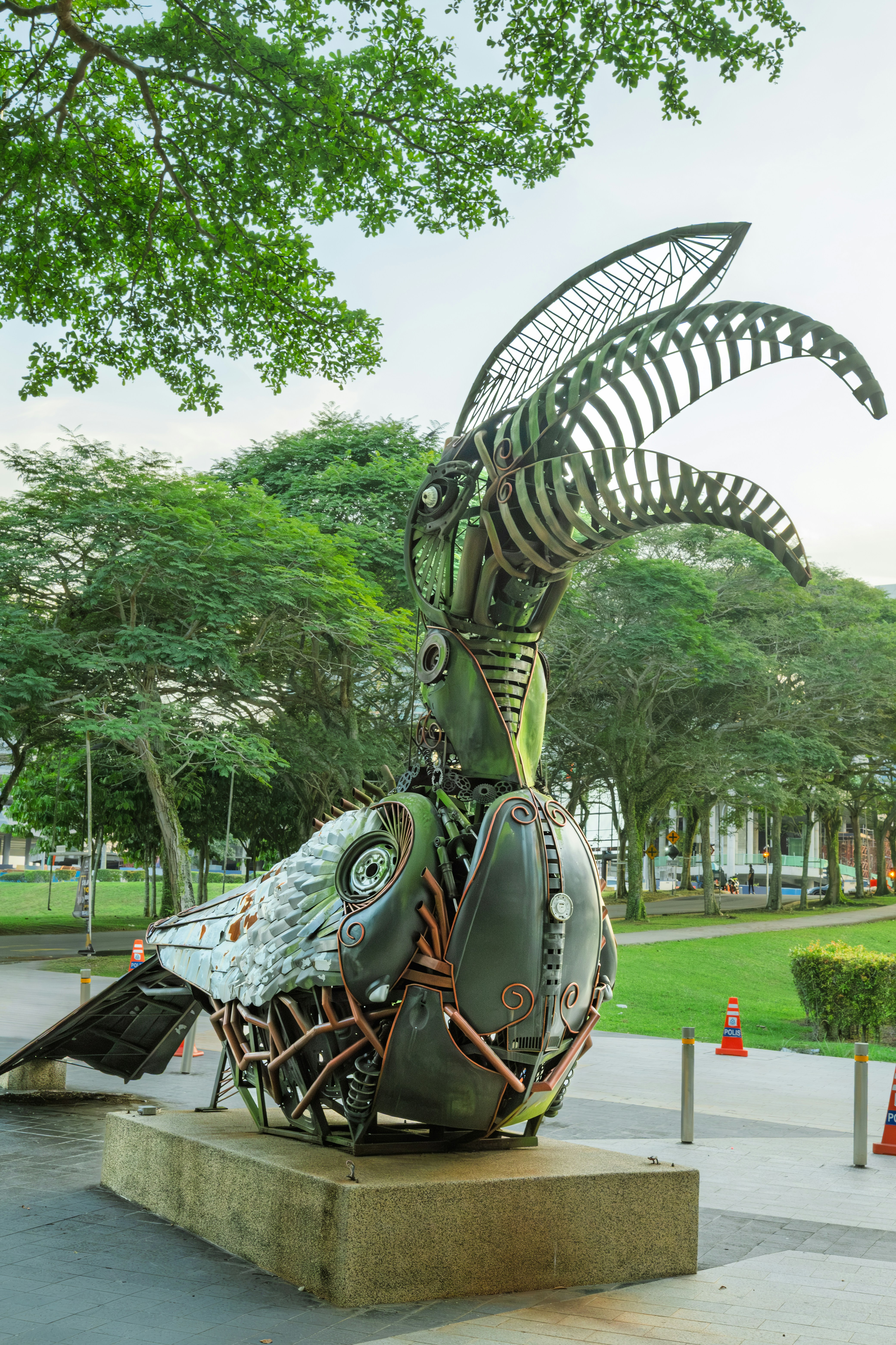 Metal sculpture of a bird with intricate details.