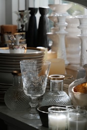 Collection of decorative vases, glasses, and candles