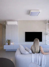 Woman relaxing on sofa in modern living room