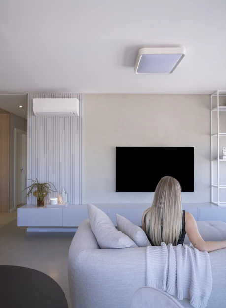 Woman relaxing on sofa in modern living room