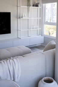 Modern living room with neutral tones and large window