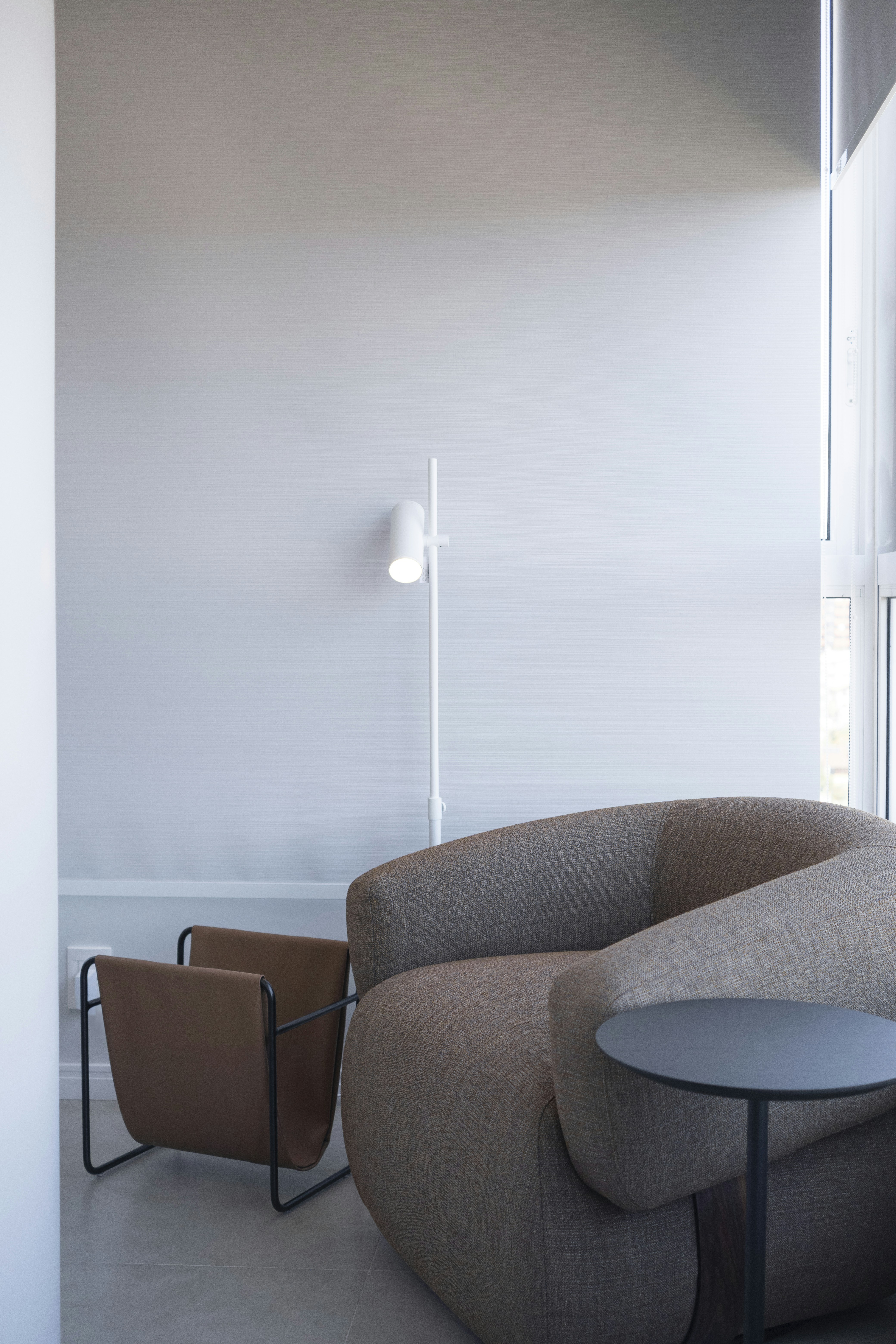 Modern armchair and side table in a bright room.