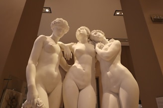 Three classical marble statues of women