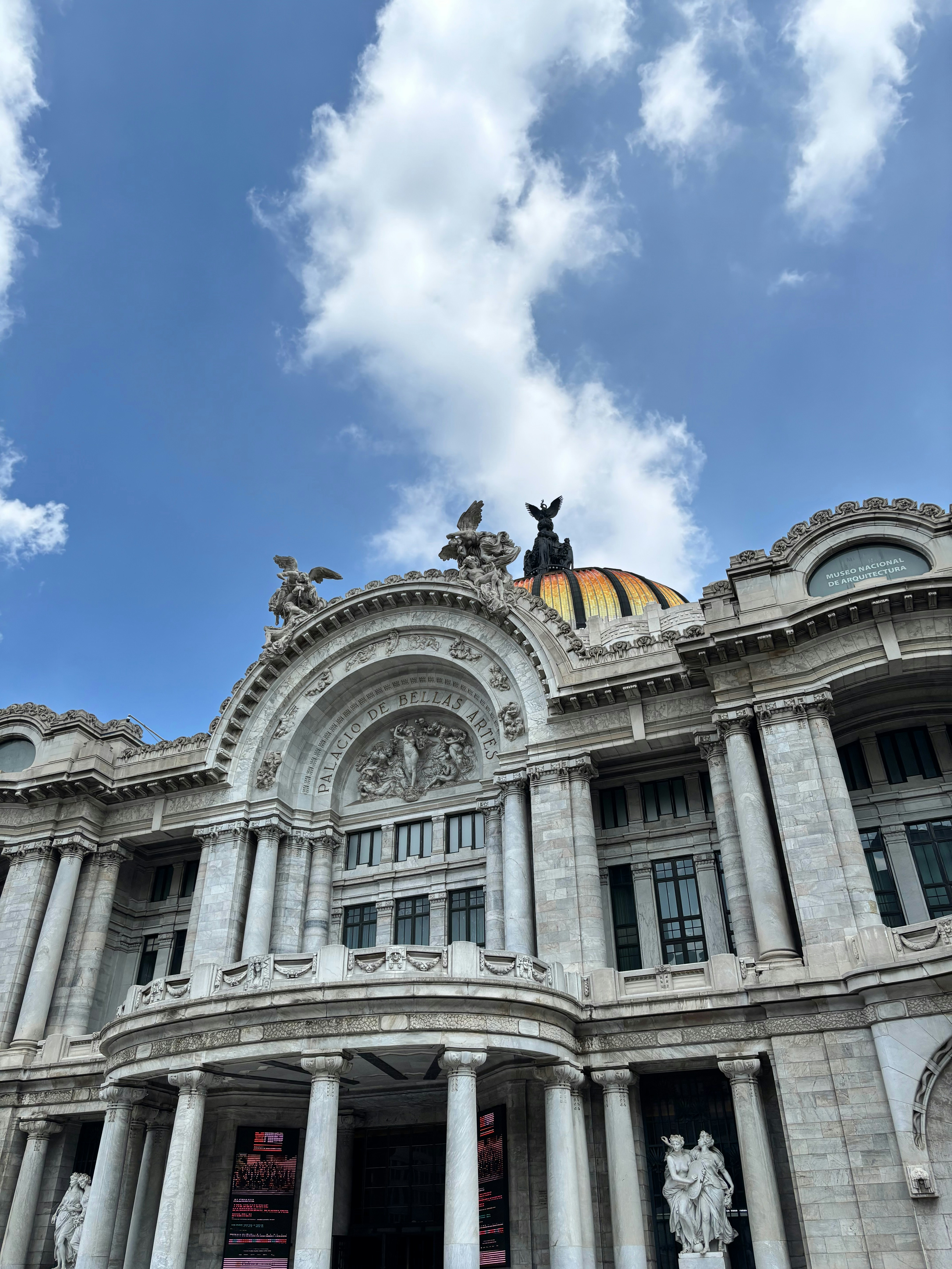 Grand ornate building with a dome under blue sky